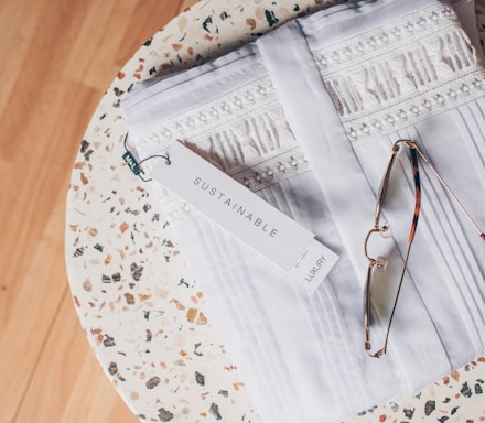 silver framed eyeglasses on white and blue floral textile