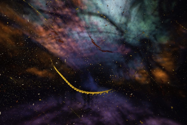 Abstract visual with a cosmic feel, featuring a blend of swirling colors including blue, purple, and orange. Thin, curved, yellow lines cut across the dark, starry background, resembling deep space or a nebula.