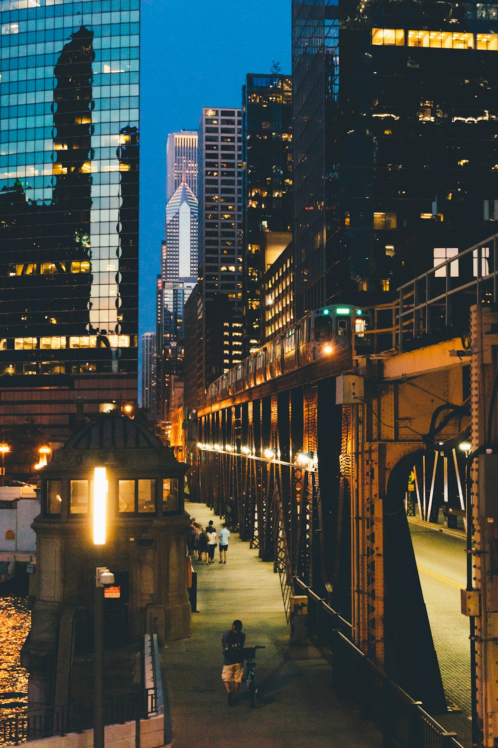 people walking on sidewalk near buildings during night time