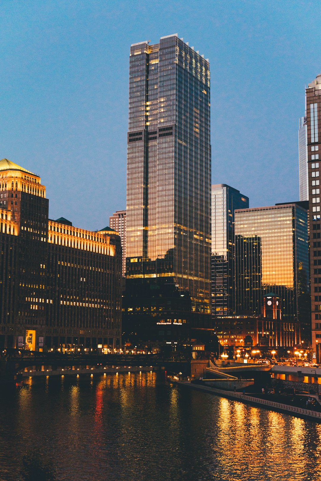 city buildings near body of water during night time