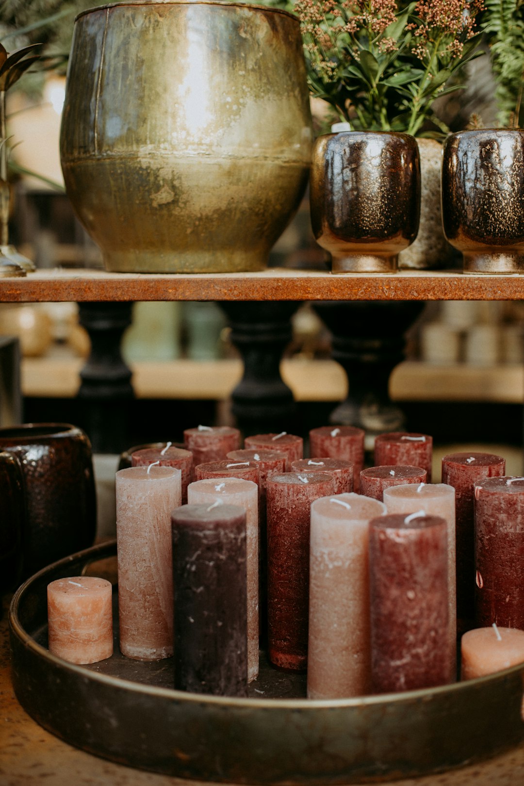 pink and gold candles on brown wooden rack