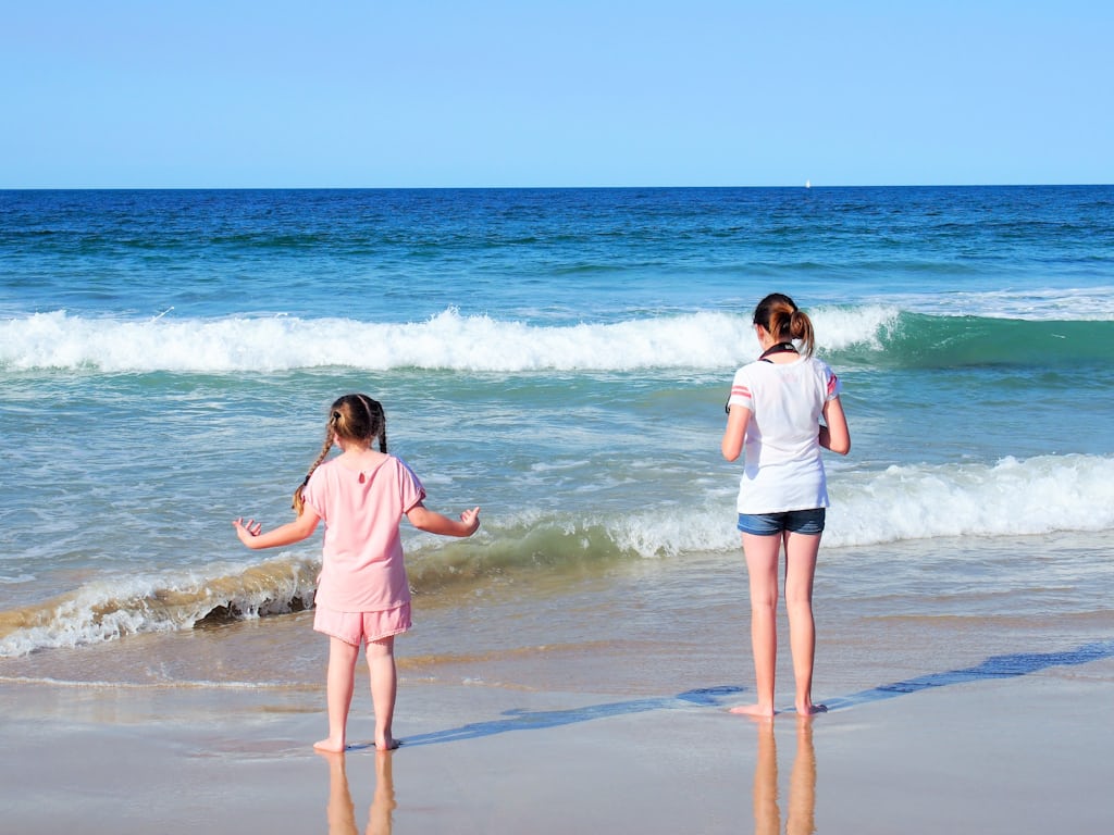 Kiwis relaxing on the beach in Gold Coast QLD — Relocating for a relaxed lifestyle
