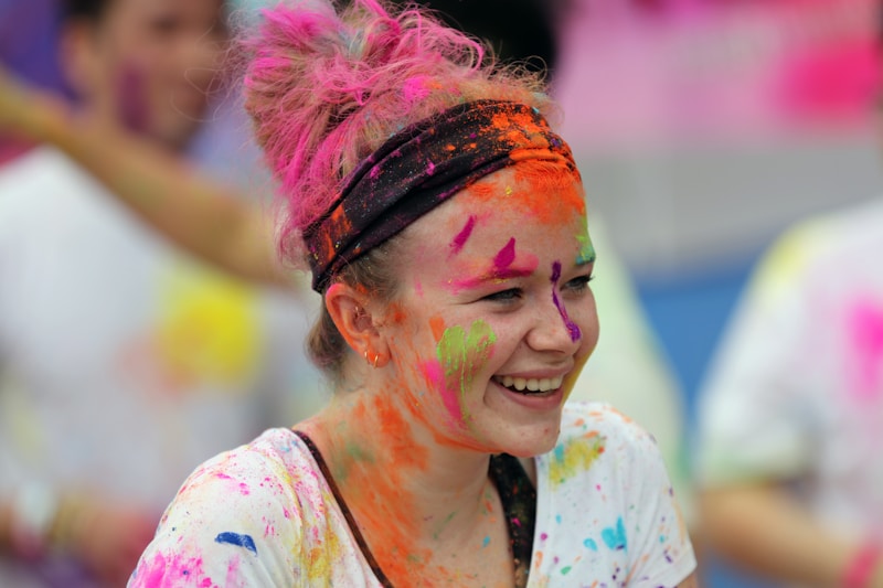 smiling woman in white and pink floral shirt