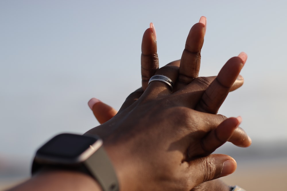 person wearing silver ring and silver ring