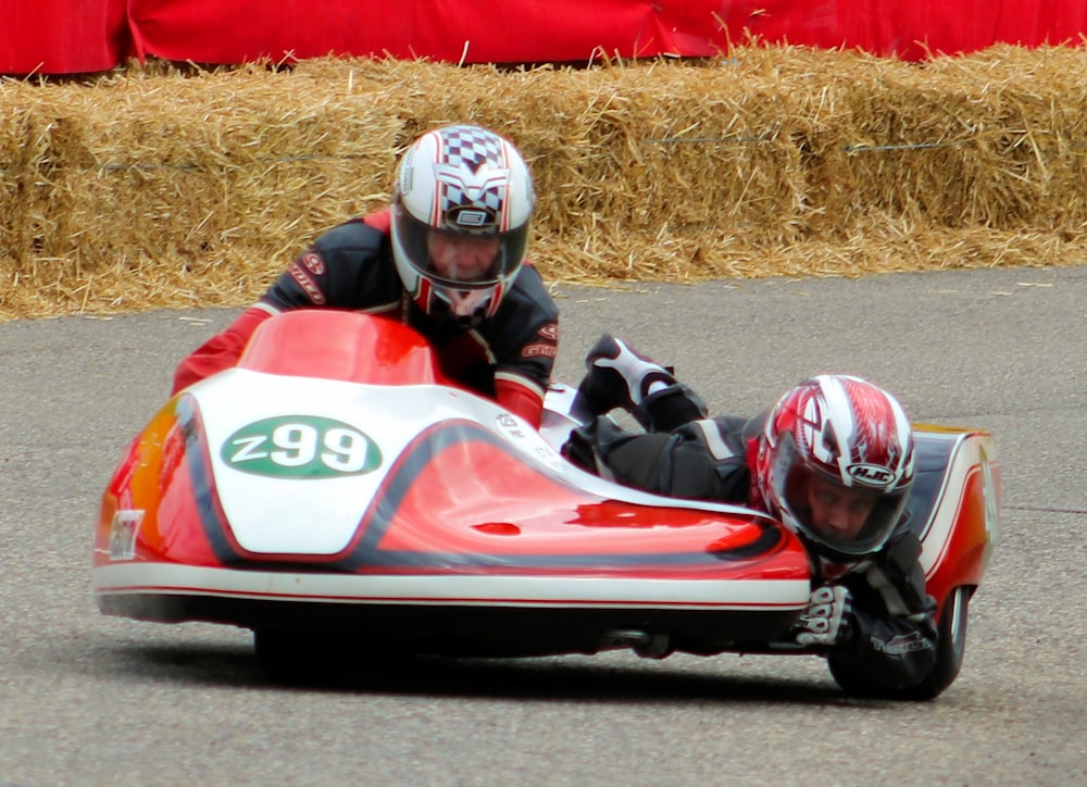 man riding on red and white go kart