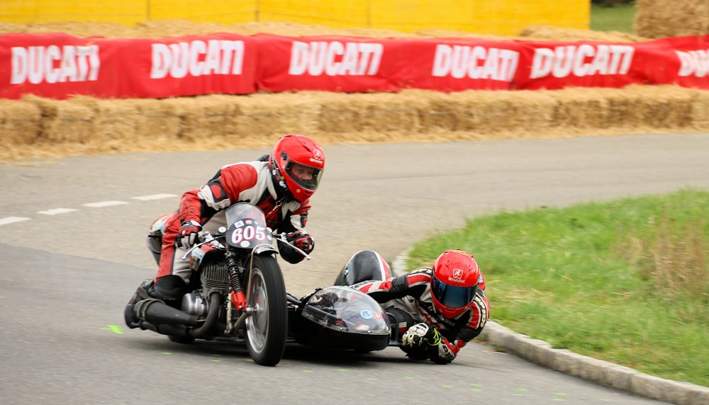 man in red helmet riding sports bike on track field during daytime