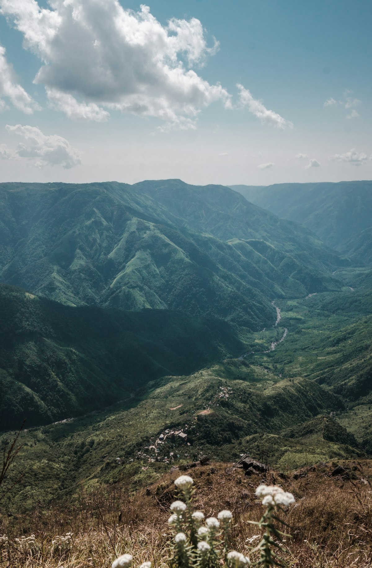 Rolling green hills disappearing into clouds at Laitlum Canyon, Meghalaya