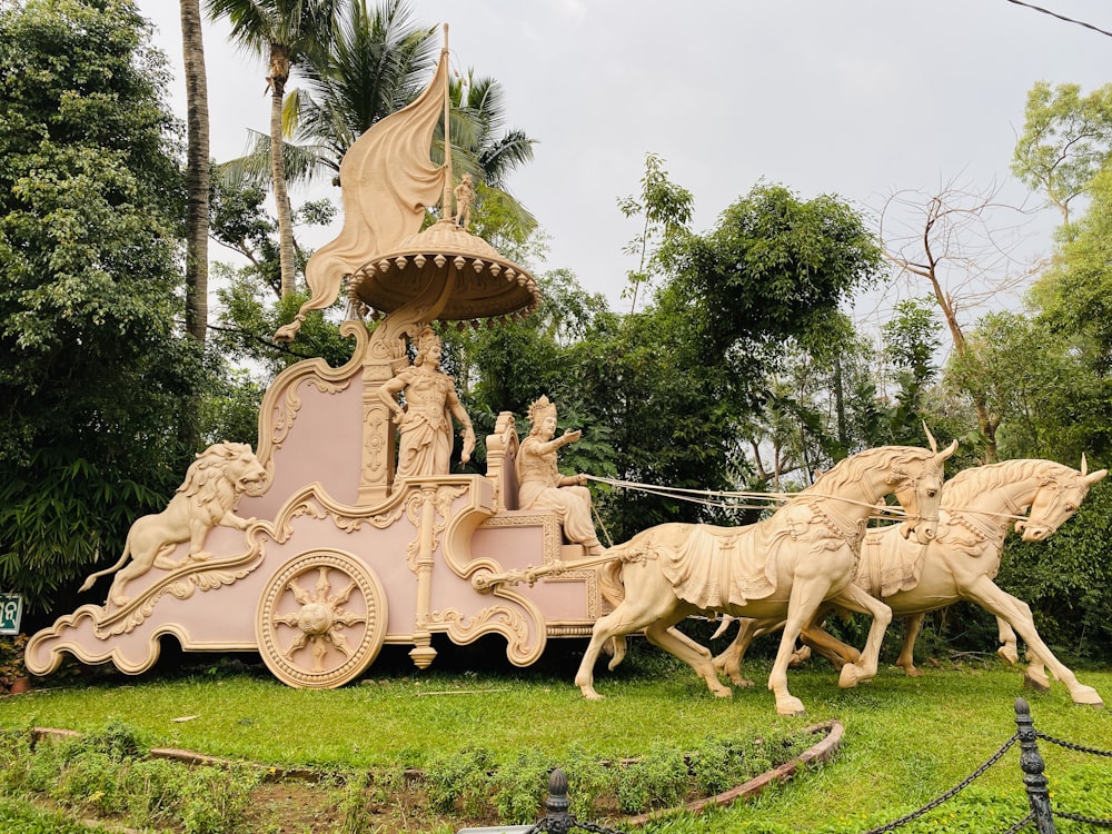 white horse carousel on green grass field during daytime