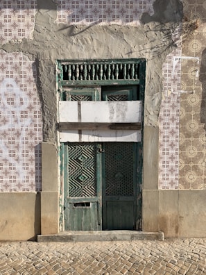 green wooden window on white concrete wall