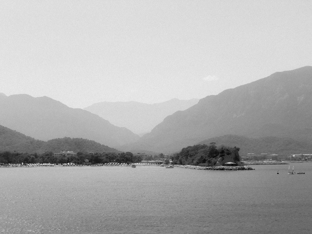 body of water near mountain during daytime