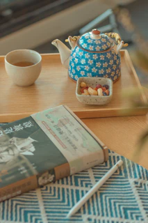 An overhead shot of a cozy tea setup with k butterfly® supplements and a journal open to wellness notes.