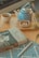 A cozy kitchen scene with a bowl of seasoned peanuts and a cup of tea on a wooden table.