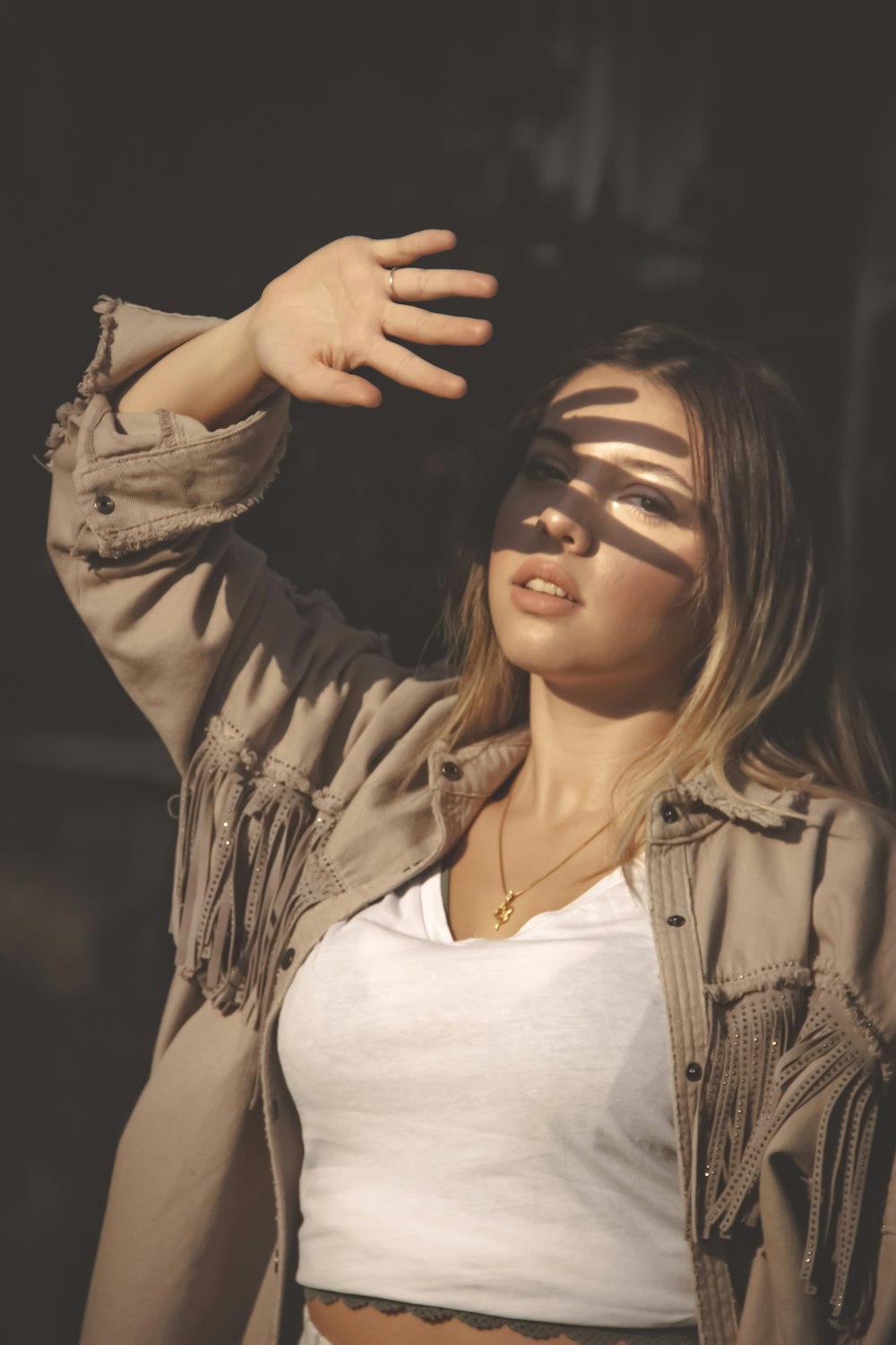 woman in white shirt and brown jacket