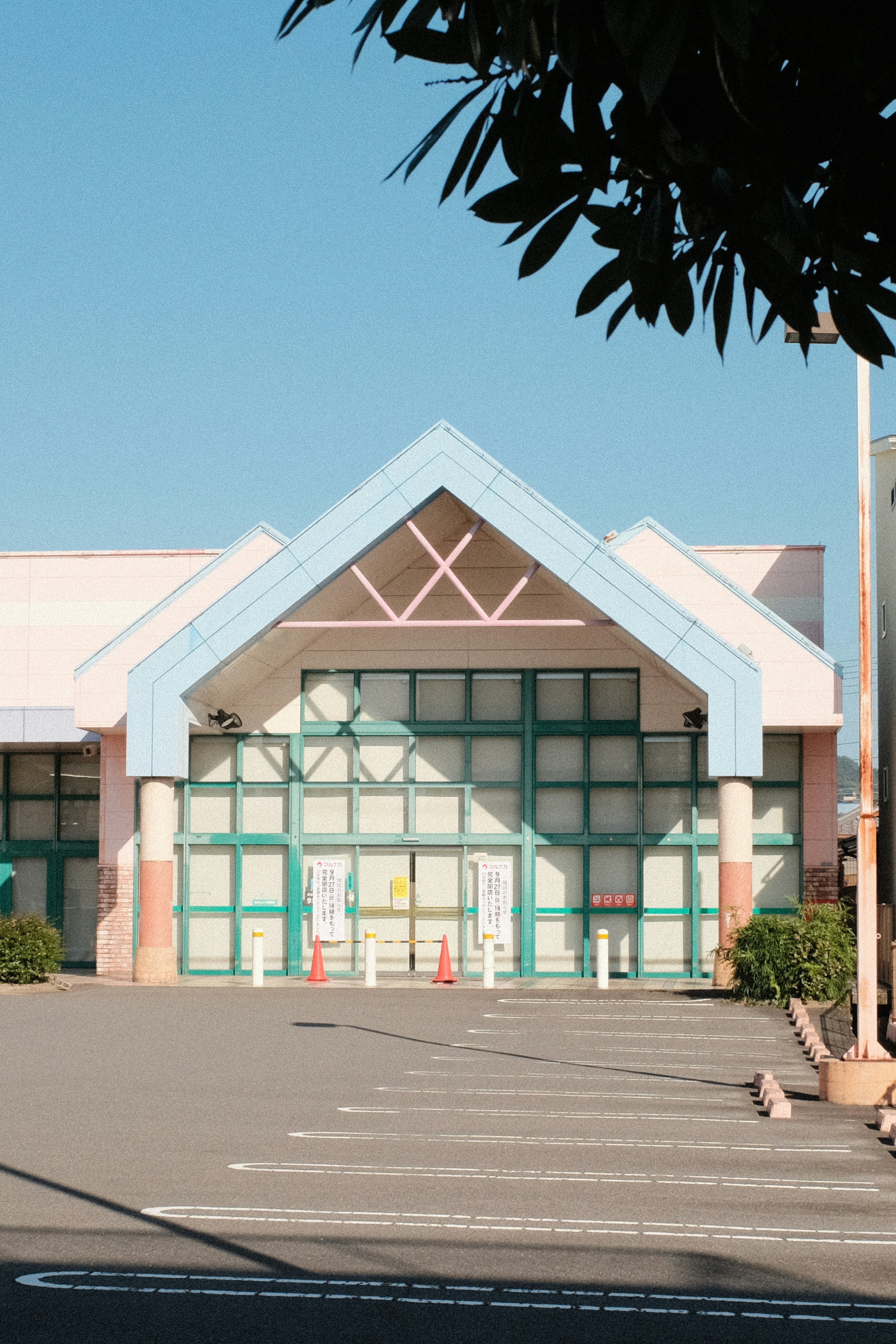 white and teal concrete building near palm tree during daytime