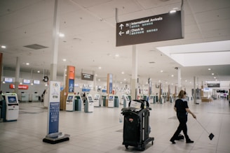 A friendly staff member carefully packing a lost item at Barcelona airport.