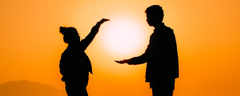 silhouette of man raising his hands