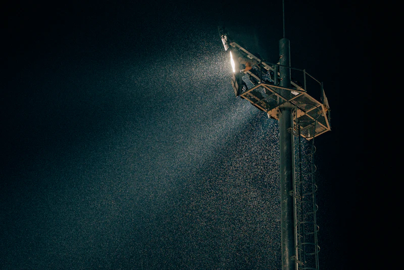 A compact stadium bowl lit up on an evening