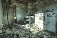Close-up of soot-covered furniture and belongings inside a fire-affected room.