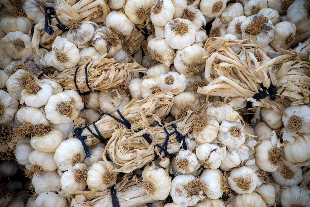 white garlic on black metal rack