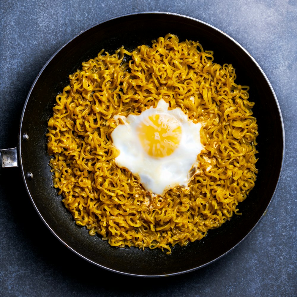 brown rice on black frying pan