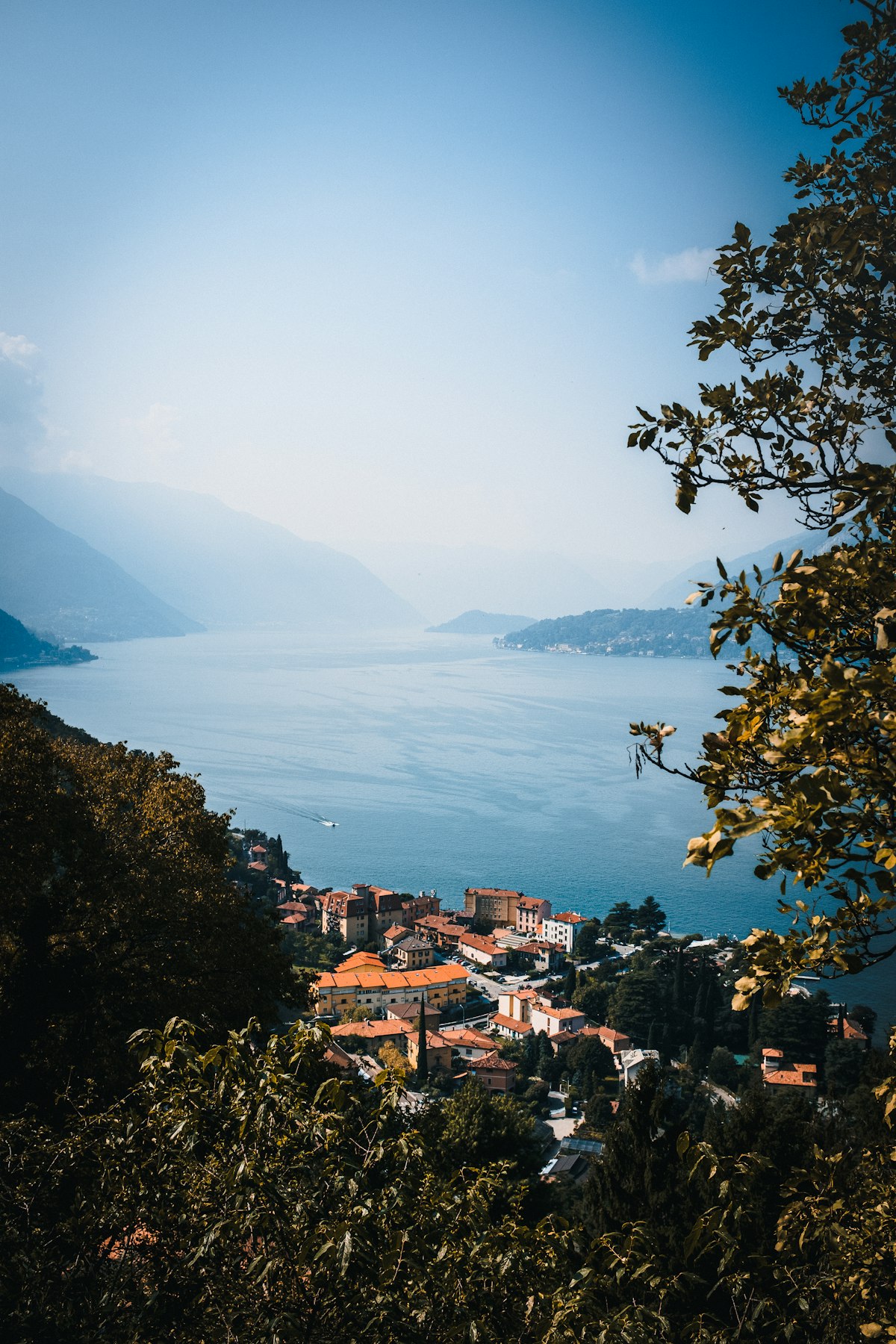 November fog-covered Lake Como with shuttered Varenna village in distance