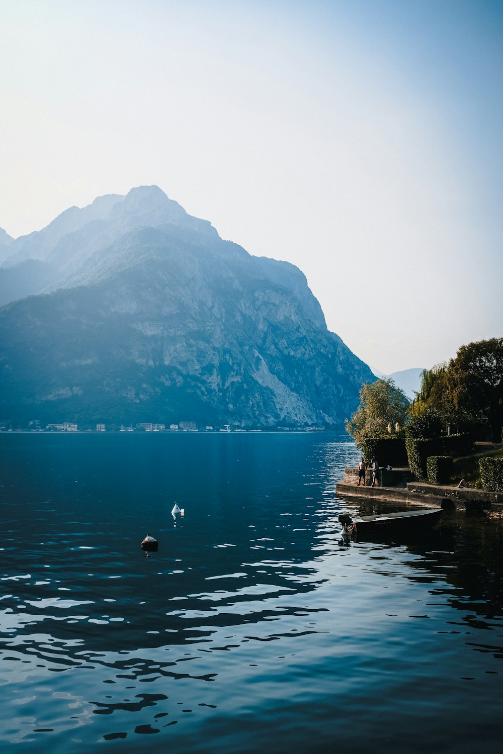 person riding on boat on lake during daytime