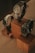 Three elegant watches are displayed on wooden blocks. Each watch features a metallic band and a round face, with varied designs and color schemes. The arrangement showcases the watches from different angles, emphasizing their craftsmanship and style.