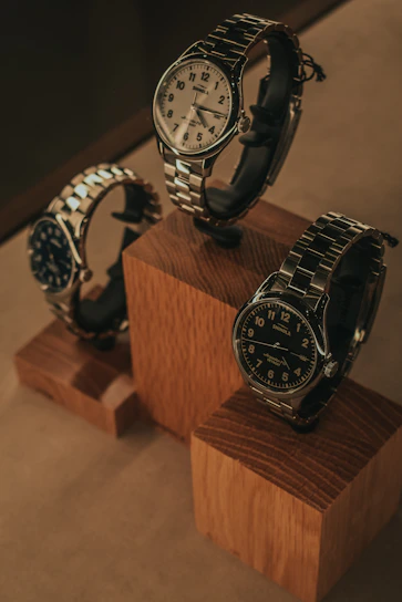 A sleek display of Mr. Ishii's signature handcrafted watches arranged on a minimalist wooden table.