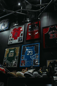 Close-up of a framed, autographed NBA jersey displayed with museum-quality lighting.