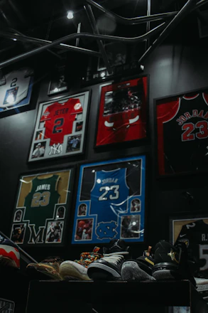 A beautifully framed signed jersey displayed alongside collectible sports memorabilia.