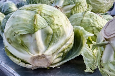 Fresh green cabbage heads neatly stacked in a market