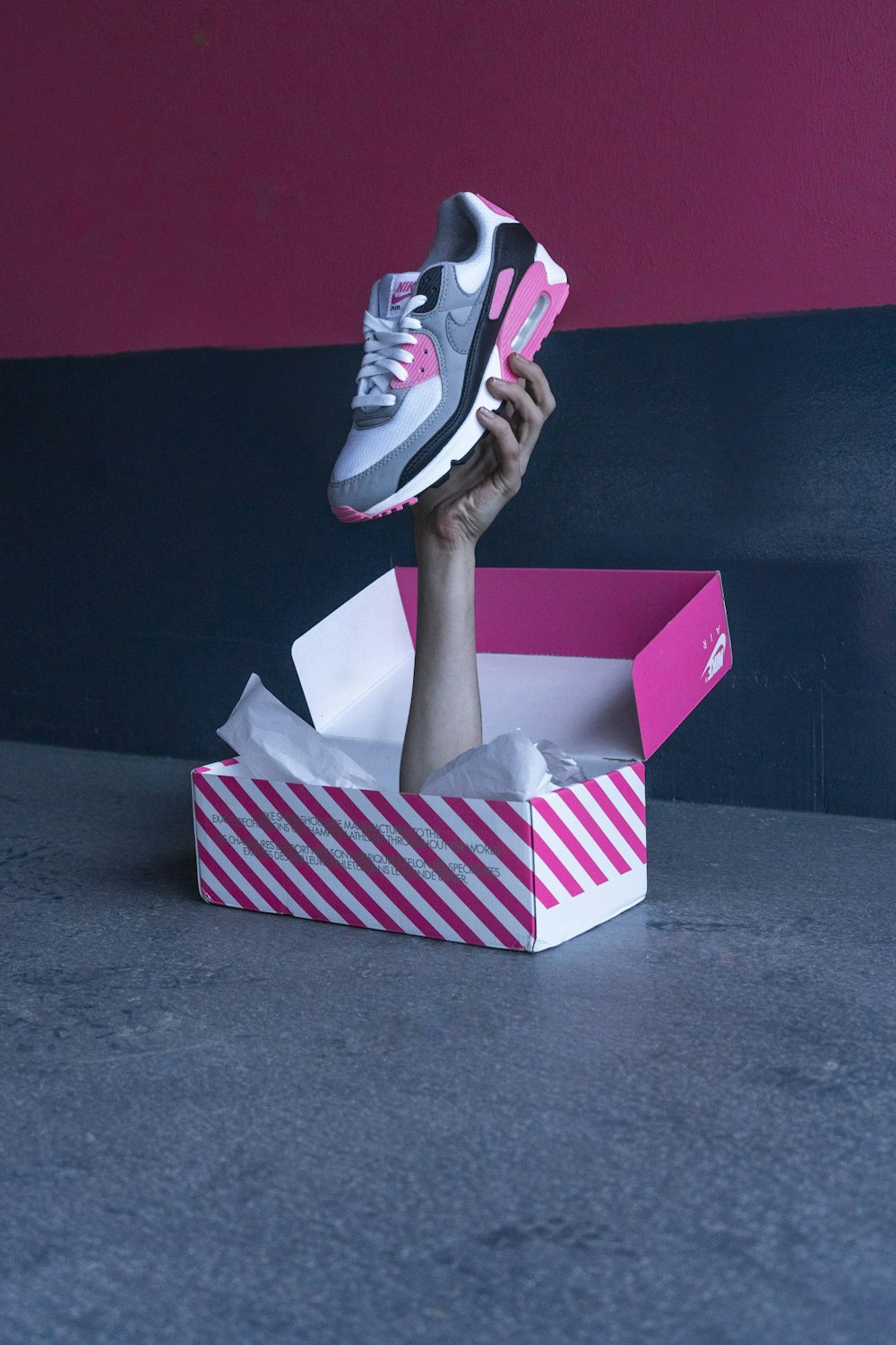 person holding white and red heart print box