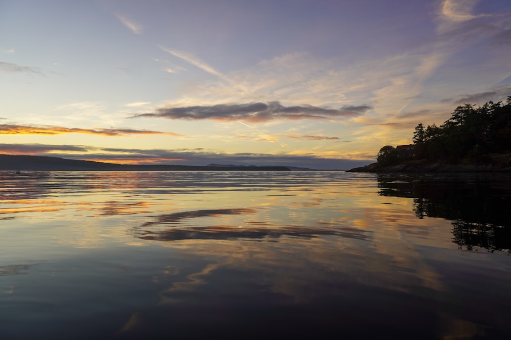 body of water during sunset