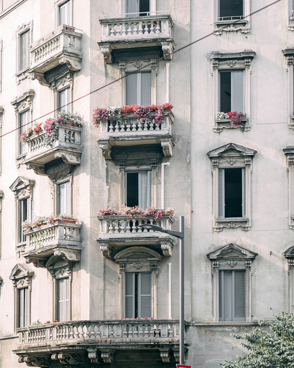 red and white floral window curtain on white concrete building