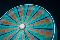 Detail of Kronos Bearings logo on a spinning wheel under neon lights.