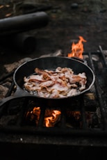 black cast iron pan with fire