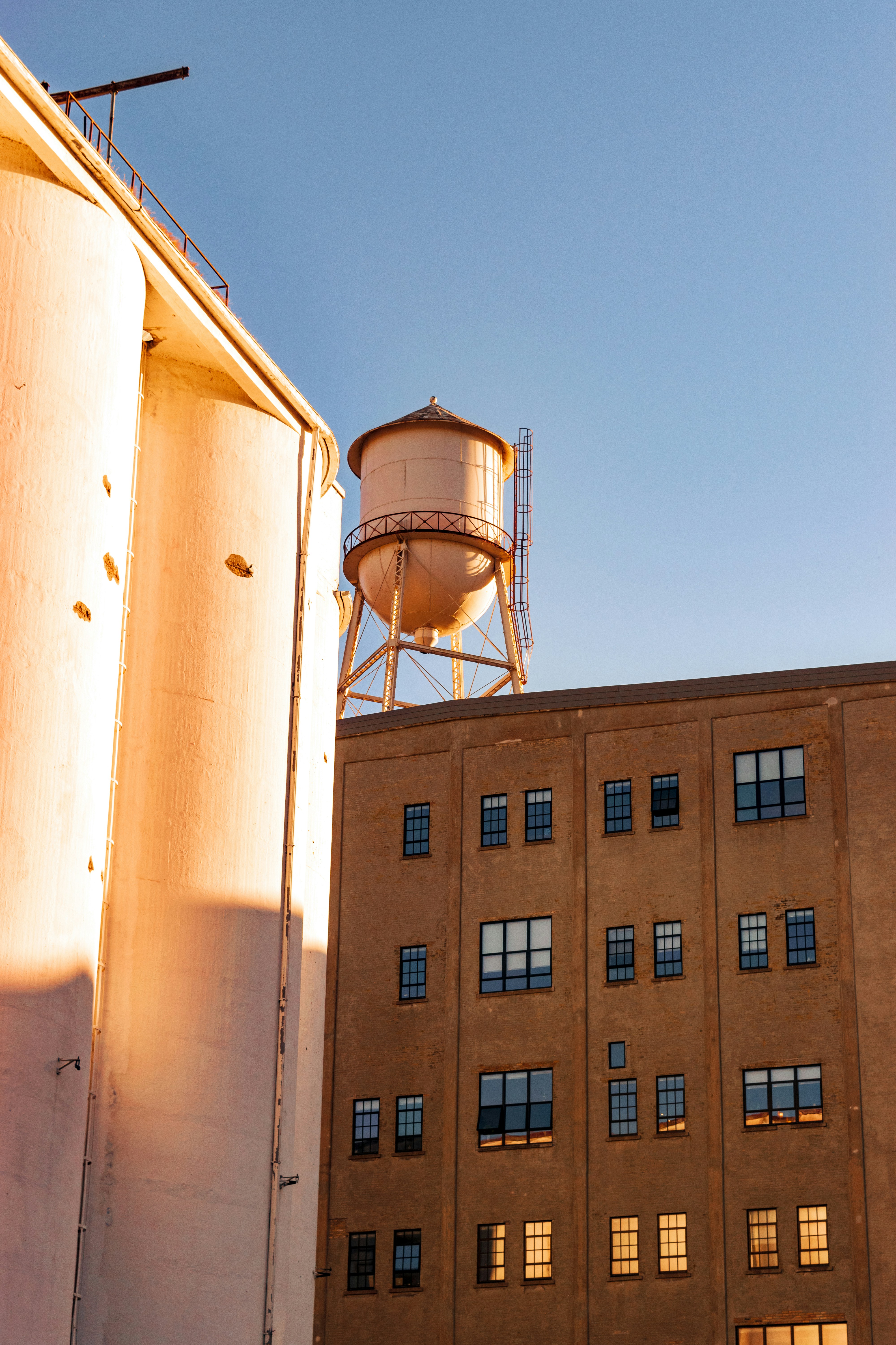 a water tower and some architecture in minneapolis, minnesota at sunset