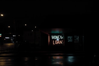 a neon sign is lit up in the dark