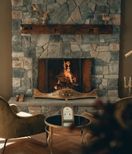 Cozy fireplace corner inside a hotel room creating a warm ambiance.