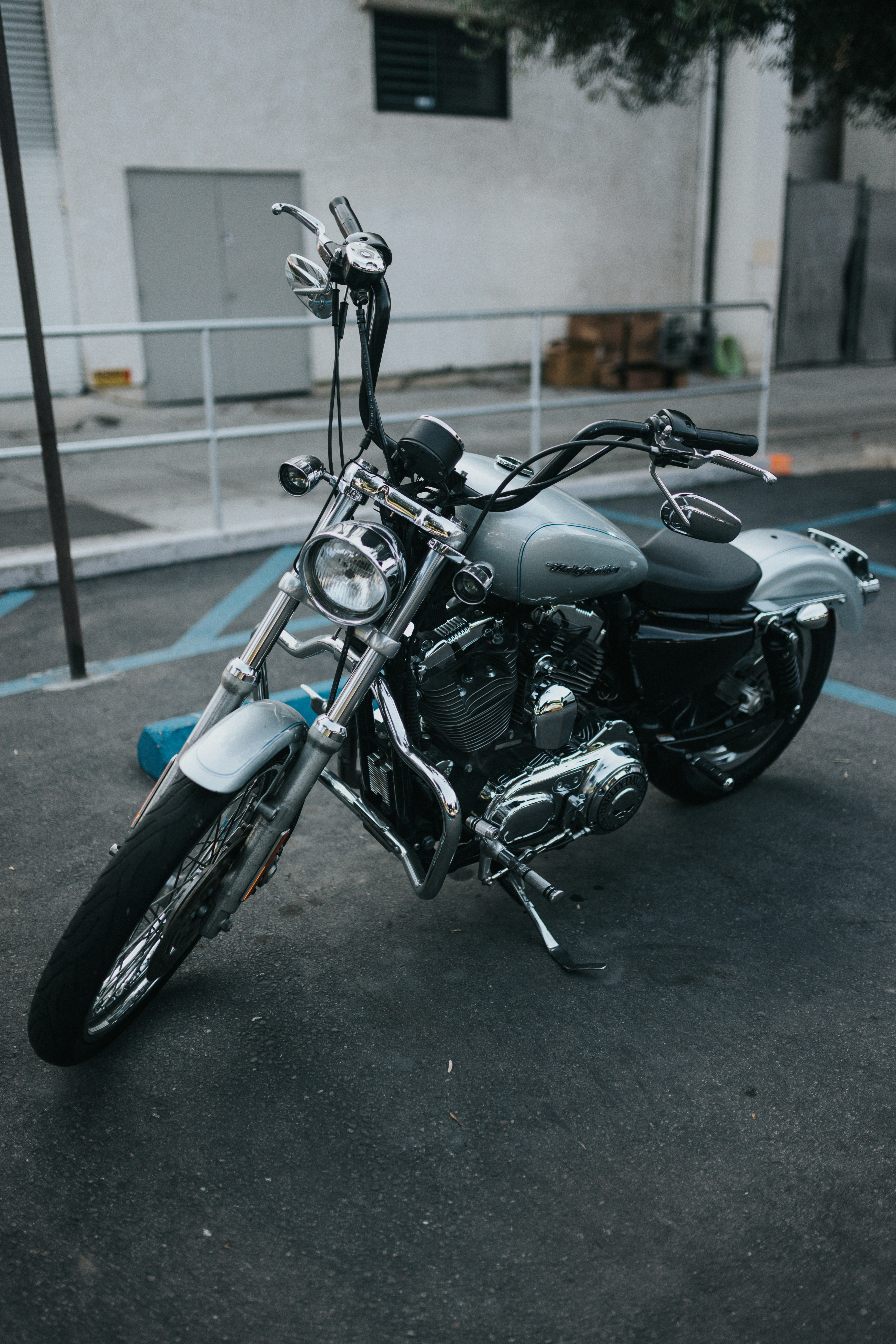 black and blue motorcycle parked on gray concrete floor during daytime