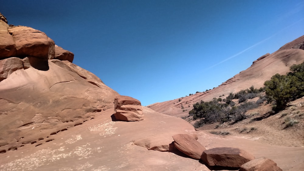 brown rock formation under blue sky during daytime