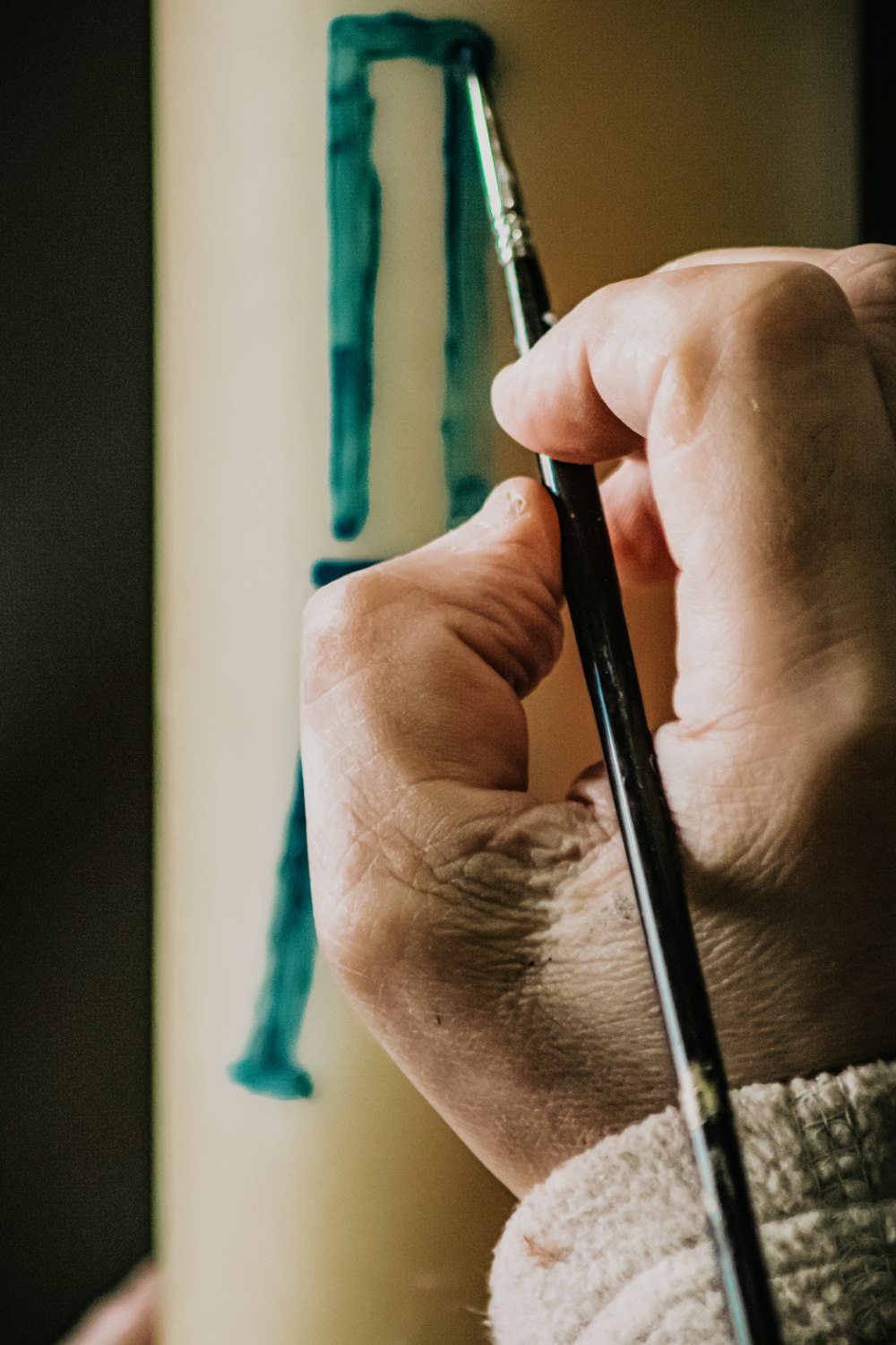 person holding black pen in close up photography