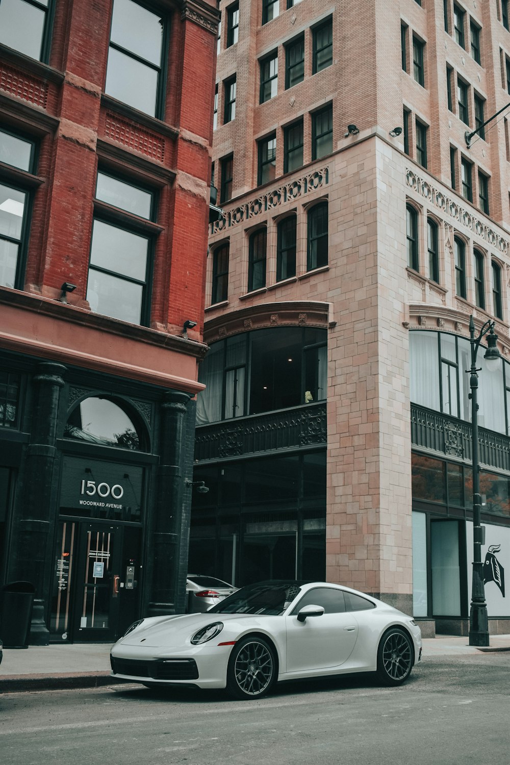 cars parked in front of brown building