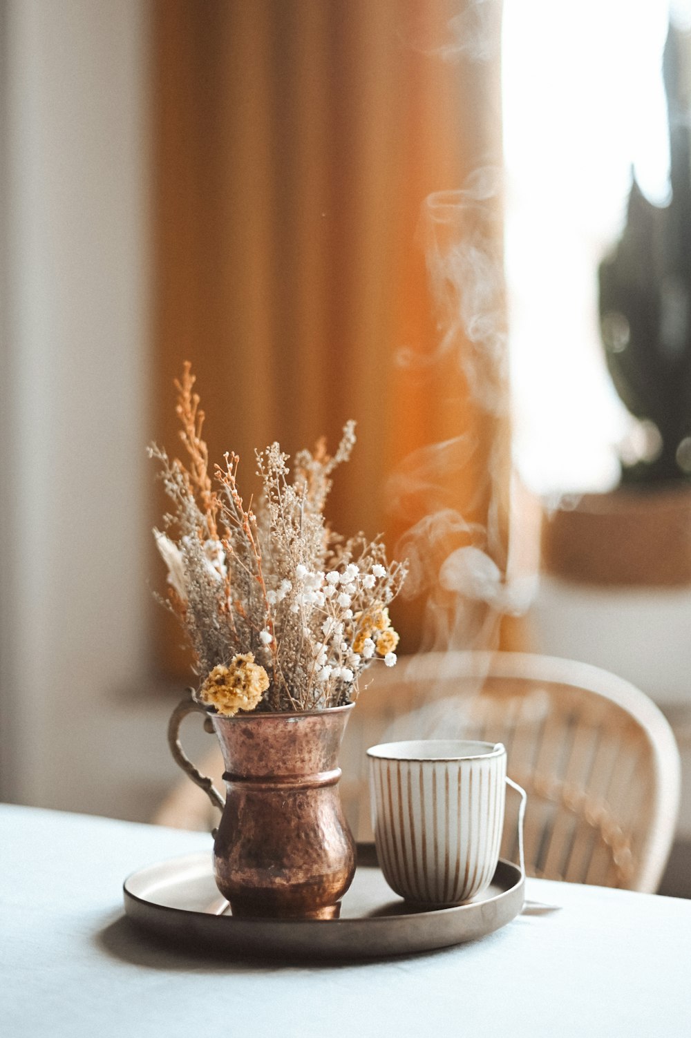 white flowers in brown ceramic vase