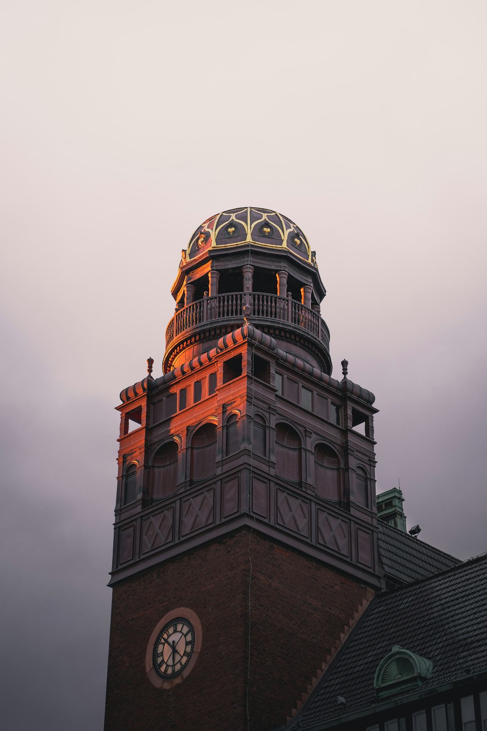 brown concrete building under gray sky