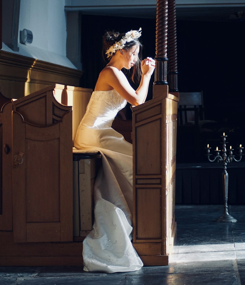 woman in white dress holding black smartphone