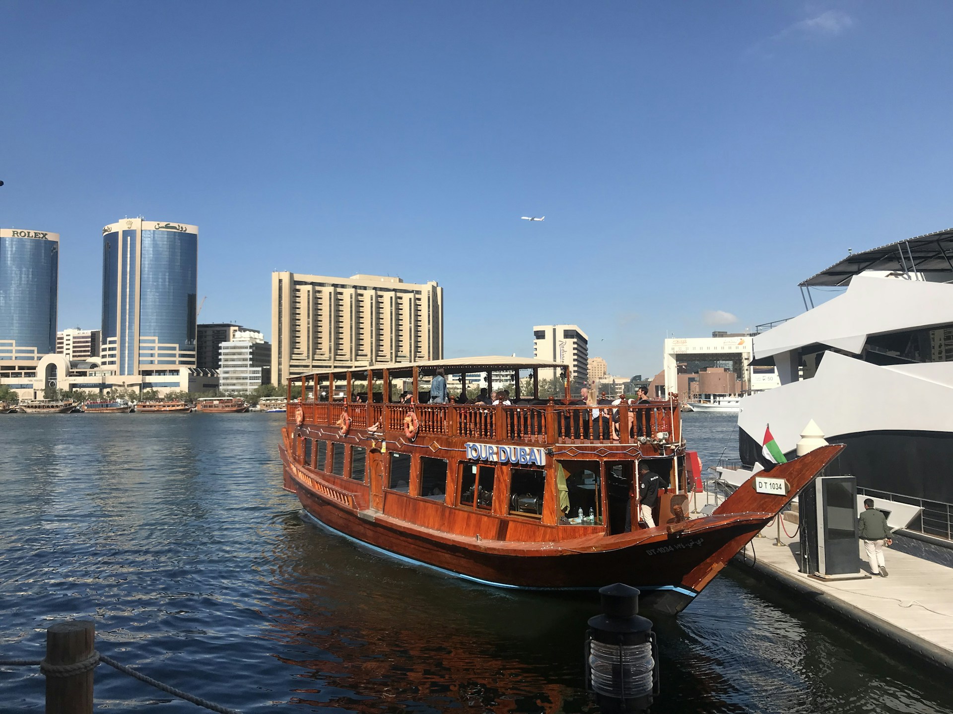 brown boat on body of water near city buildings during daytime