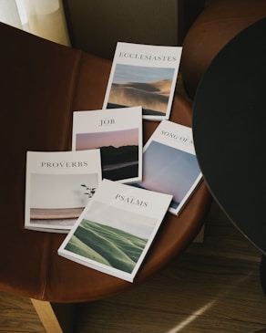 white and green book on brown wooden table