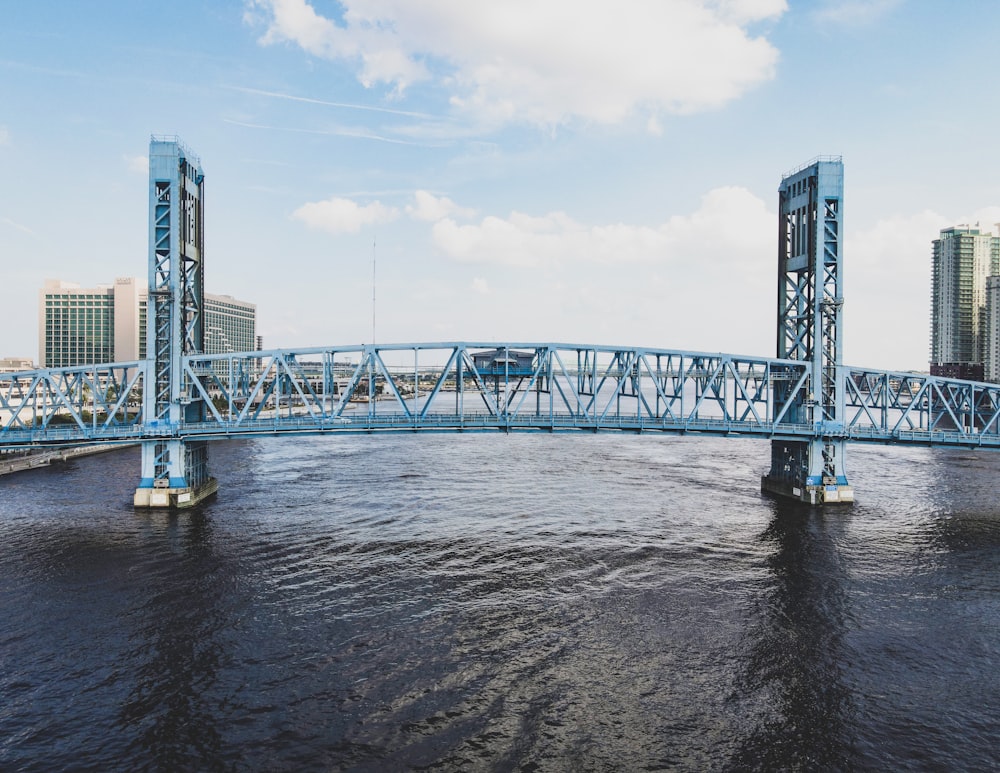 gray metal bridge over water during daytime