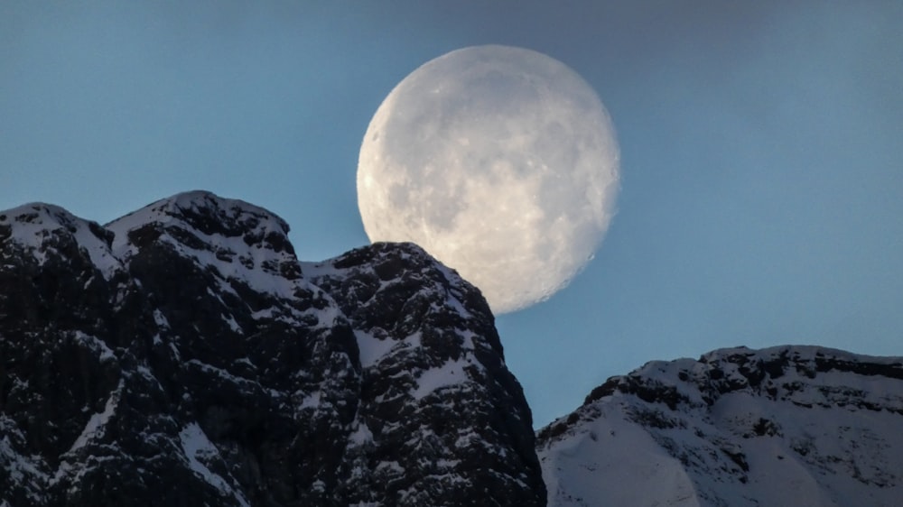 snow covered mountain under full moon